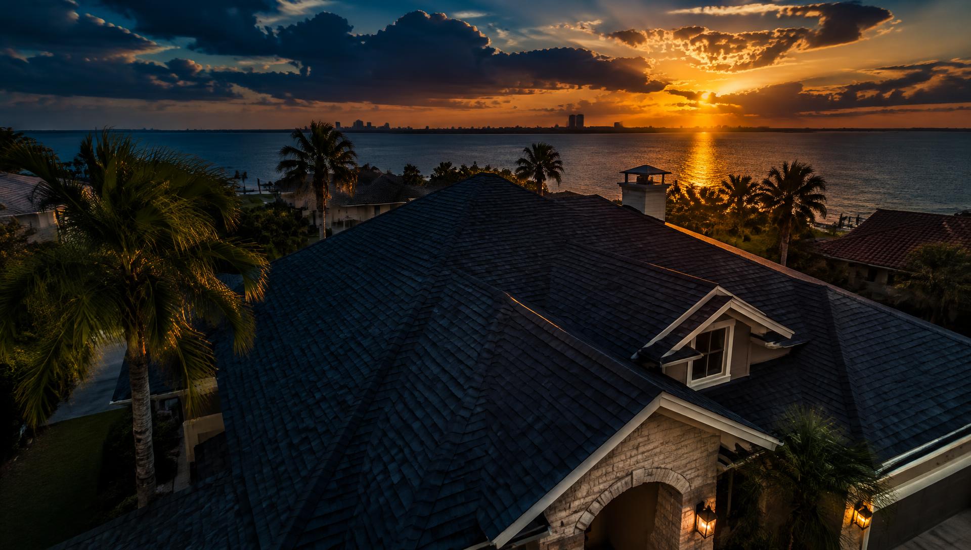 Home with a rejuvenated shingle roof at sunset